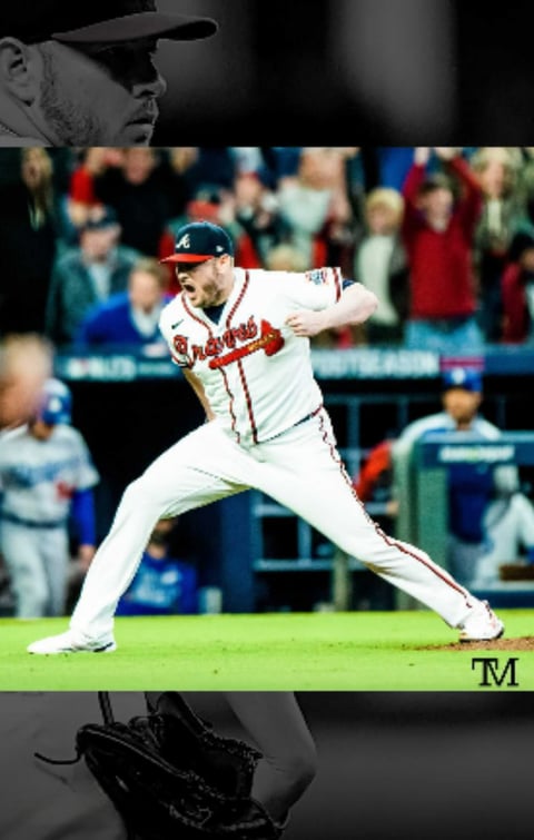 Baseball player in red Atlanta Braves uniform executing a bunt during a game with crowd in background